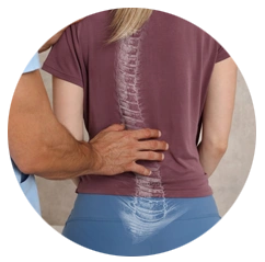 Person shown from behind with a hand on the lower back