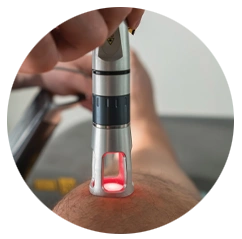 Close-up of a handheld shockwave therapy device