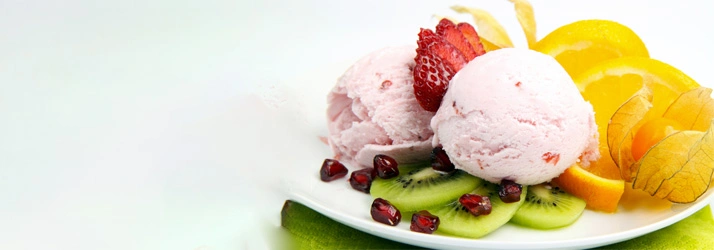 Two scoops of strawberry ice cream served on a plate